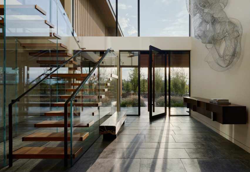 Entryway with glass staircase