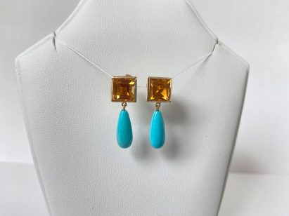 A photograph of an amber glass and blue stone necklace
