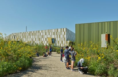 Grey and green building with plans Thaden school