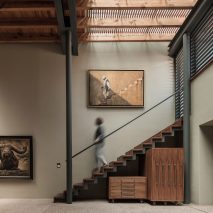 Carbonell Foundation stairway in double-height room with stone