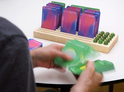 A photograph of cards placed in a wooden holder