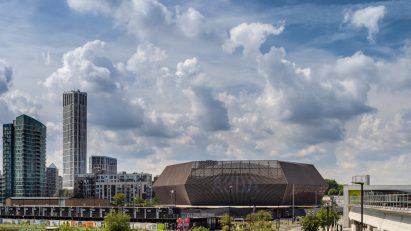 Image of the ABBA Arena among skyscrapers in the distance