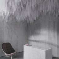 Reception of AER Skinlab in Vancouver by Leckie Studio with marble walls and stalactite-like ceiling installation