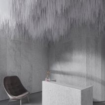 Reception of AER Skinlab in Vancouver by Leckie Studio with marble walls and stalactite-like ceiling installation