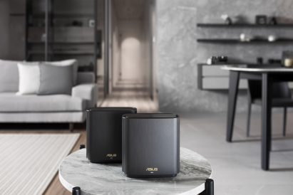 Image of two black ZenWiFi routers pictured on a round table
