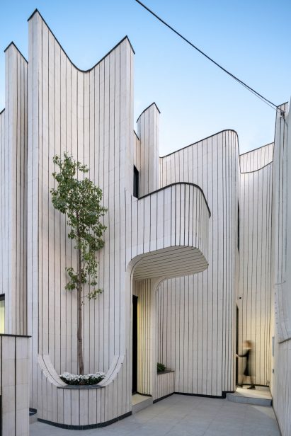 curved white-brick facade