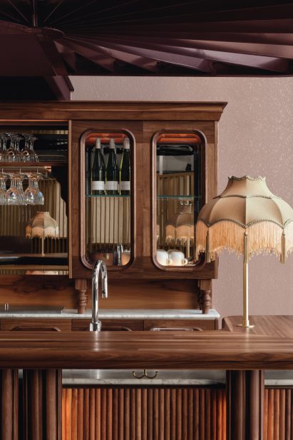 Walnut bar and golden lamp
