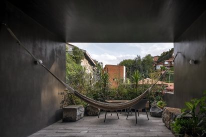 Top floor terrace with hammock and vegetation