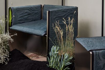 A chair and stool with blue upholstery