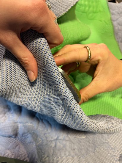 A pair of hands touching Prowl Studio fabric