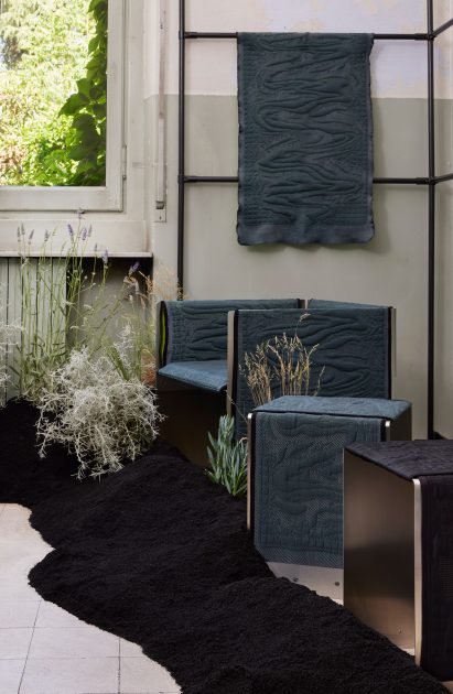 A blue chair, stool and hanging fabric