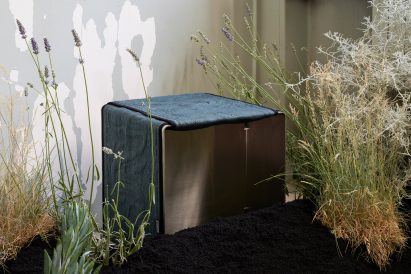 A steel stool with blue upholstery