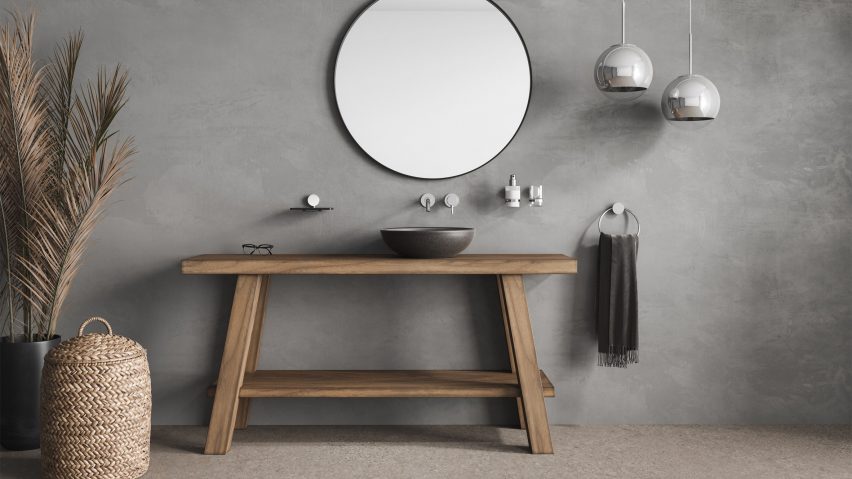 Geesa Opal towel rail used in a grey bathroom by a wooden table