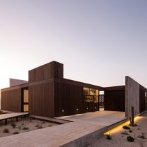 Juan Pablo Ureta orients wooden Chilean beach house around a courtyard