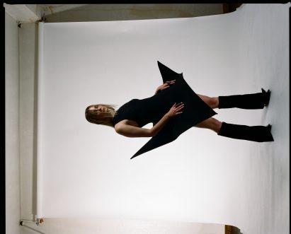 A model is pictured wearing angular clothing by a fashion design student