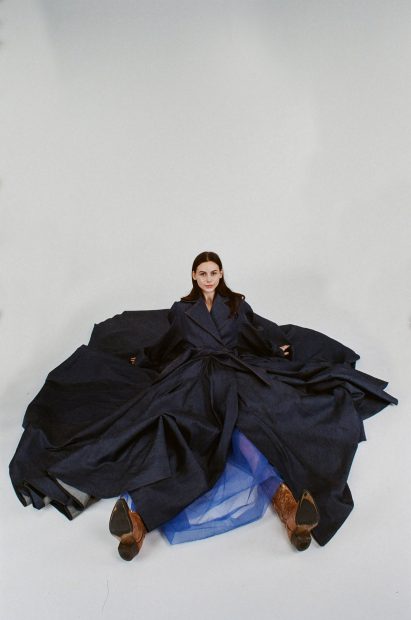 A model is pictured wearing clothes by a fashion design student