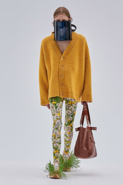 A model wears a face mask screen and grass-growing shoes at Loewe Spring Summer 2023