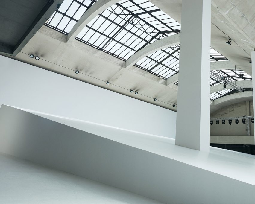 Loewe Spring Summer 2023 featured plants growing from shoes and screens fixed to coats