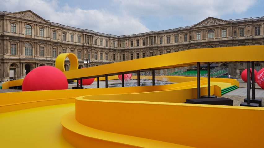 A winding yellow pathway circles around the Louvre