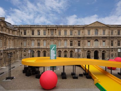 Red balloons fill the Parisian courtyard at the Louis Vuitton Spring Summer 2023 show