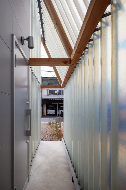 Image of the entrance to Minimum House from within corrugated translucent walls