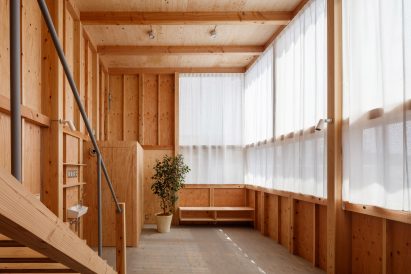 Interior image of a living area with sheer curtains at Minimum House
