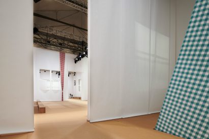 Image of paper-lined walls at the Prada Spring Summer 2023 menswear show