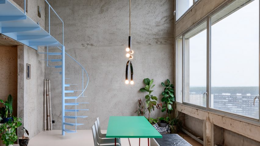 Dining area of brutalist apartment in Antwerp by Studio Okami Architecten