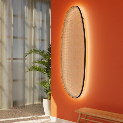 Long Sisu lamp with rattan front on an orange wall in a hallway