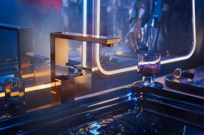 Axor Edge faucet in polished gold optic finish in dark Tristan Auer-designed bathroom