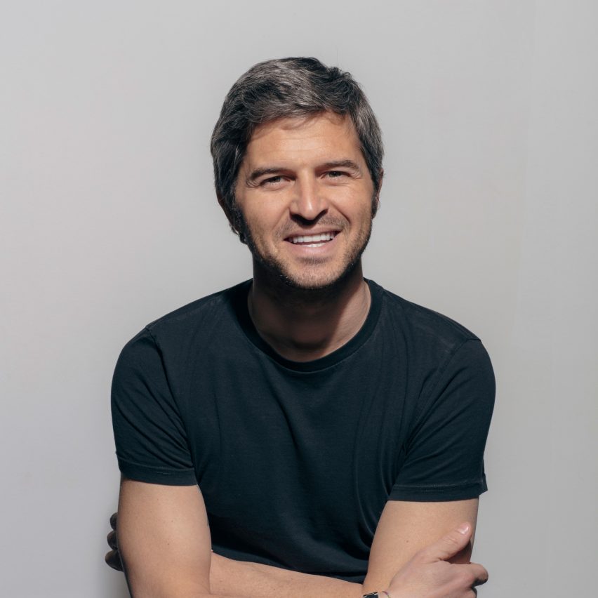 Photograph showing a man in front of a grey backdrop