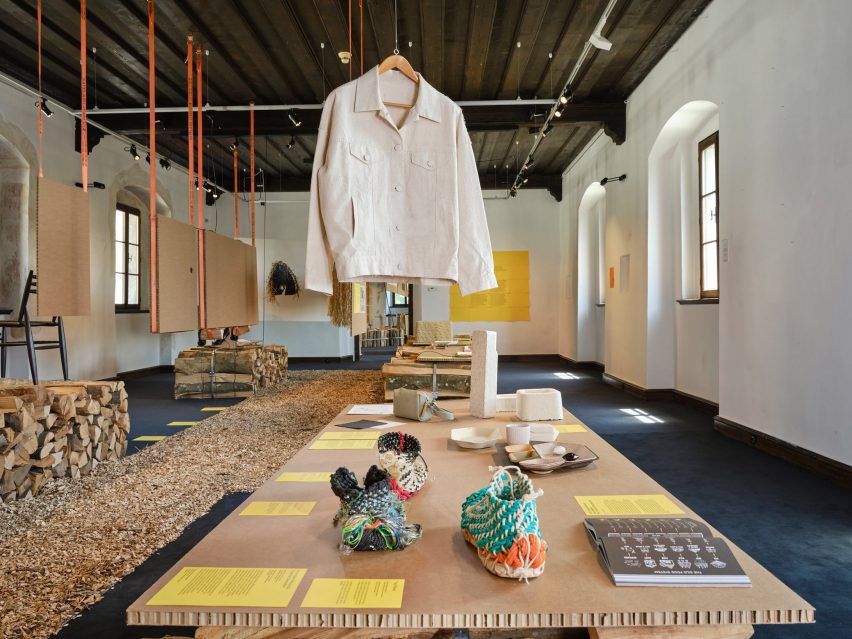 Shirt, shoes and wooden logs on display
