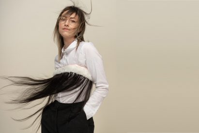A photograph of a person wearing a piece of clothing made from faux hair
