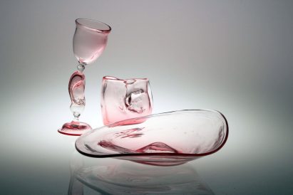 Three pink-hued glass objects