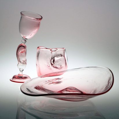 Three pink-hued glass objects