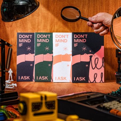 Objects and a hand holding a magnifying glass