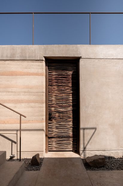 Wooden door and rammed earth walls