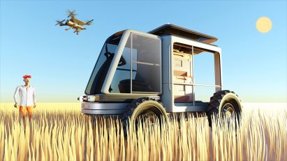 A Multi-Utility Farming Vehicle in a wheat field with a drone flying above