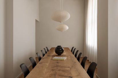 A long table with black chairs around it
