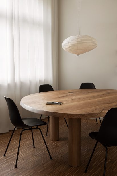 A round table with black chairs