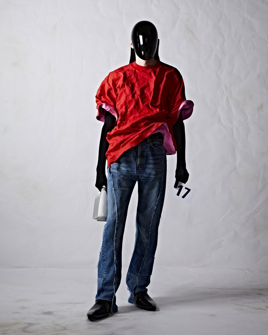 A male model wearing a bag by Balenciaga
