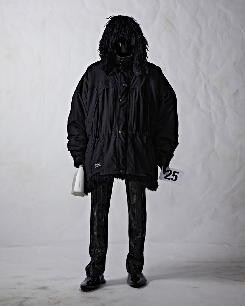 A model wearing black clothes and holding a bag