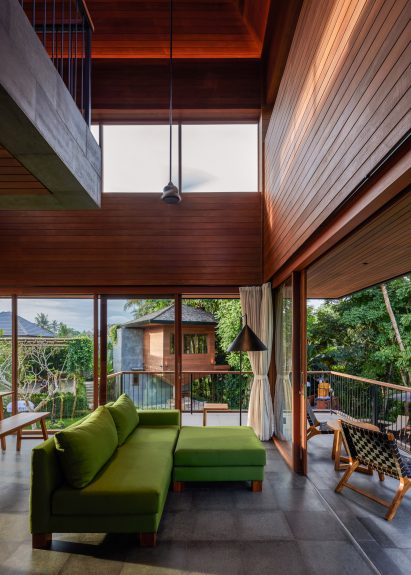 Double-height living room with wood cladding