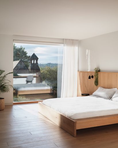Large minimalist bedroom with view of gardens and countryside in Derwent Valley Villa