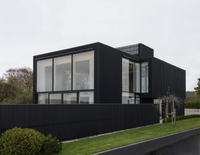 Exterior image of black Swedish house from the street