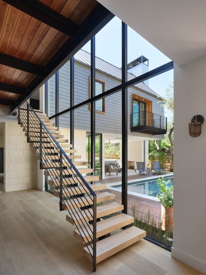 Staircase and pool with floor to ceiling windows