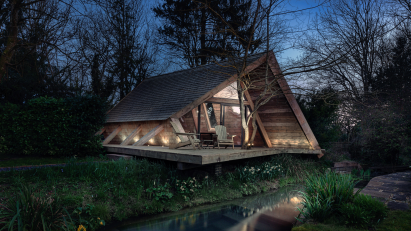 The cabin at nighttime with the lights on