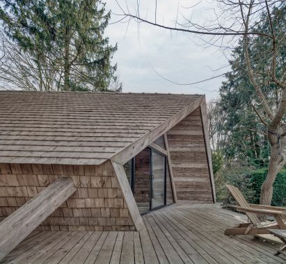 View of the cabin from the terrace highlighting it's angular roof