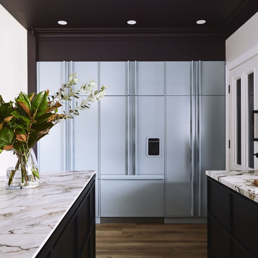 A modern kitchen with a vase of flowers on the table