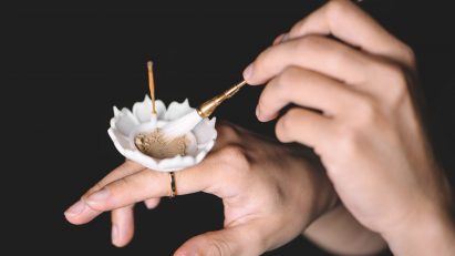 A flower-shaped dish on a ring the burns incense presented on Dezeen School Shows